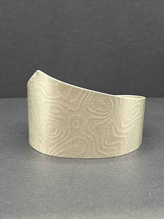 Asymmetrical patterned cuff