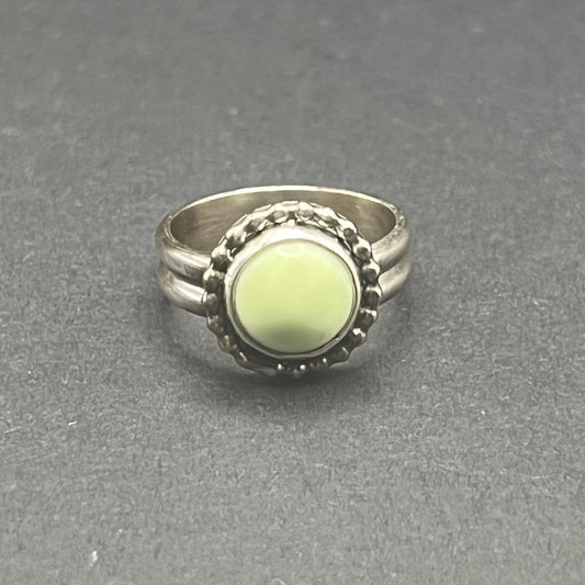 Image shows front side of Lemon Chrysoprase Feature Ring.  Stone is 10mm round, matte, sunny pale yellow color.
