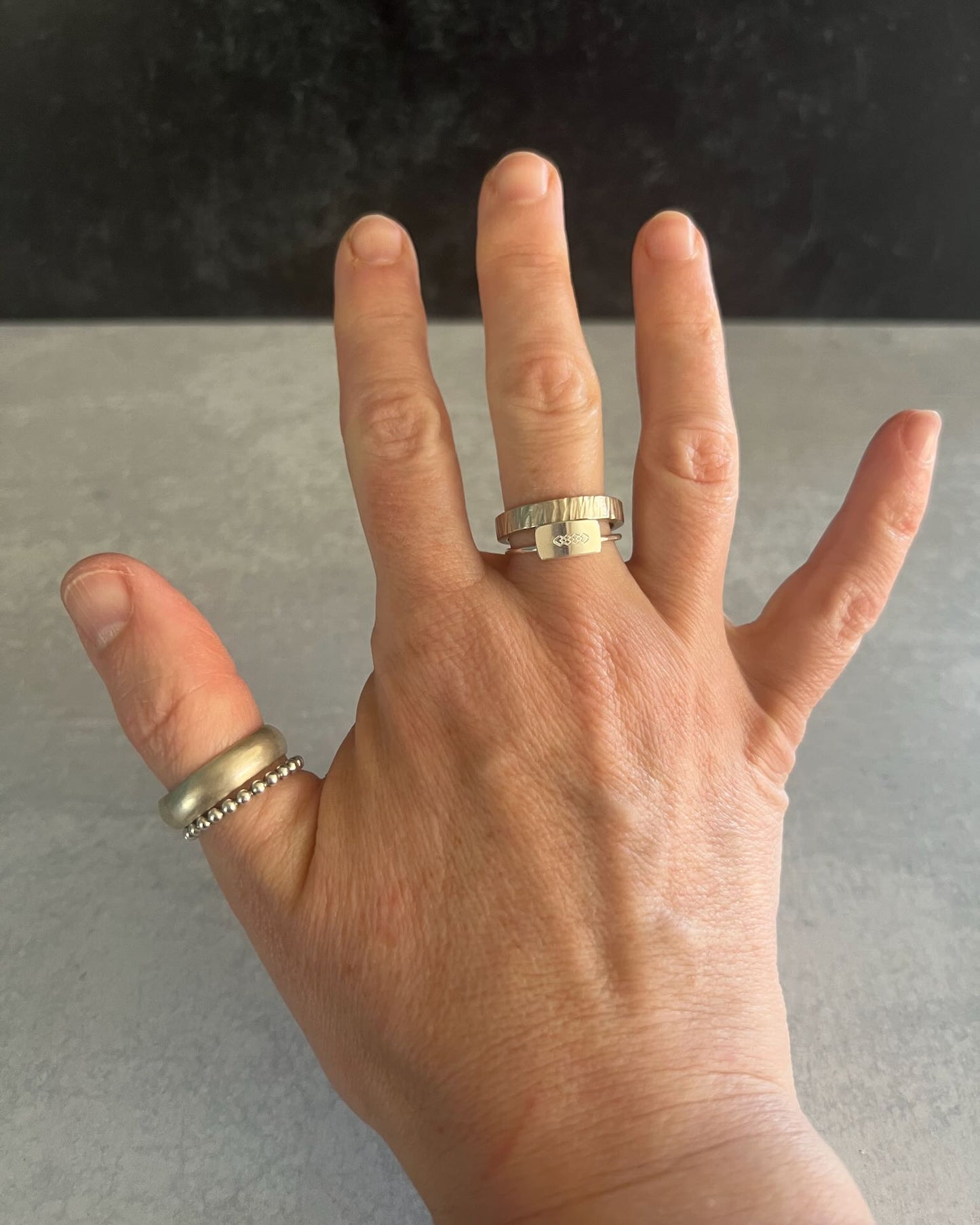 Faceted wide band ring