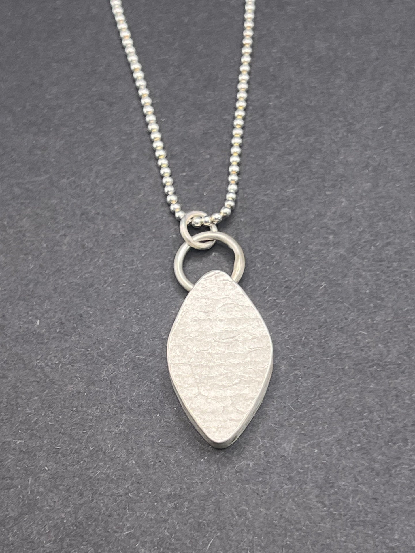 Hollow form, diamond shaped pendant (circles/cells pattern)