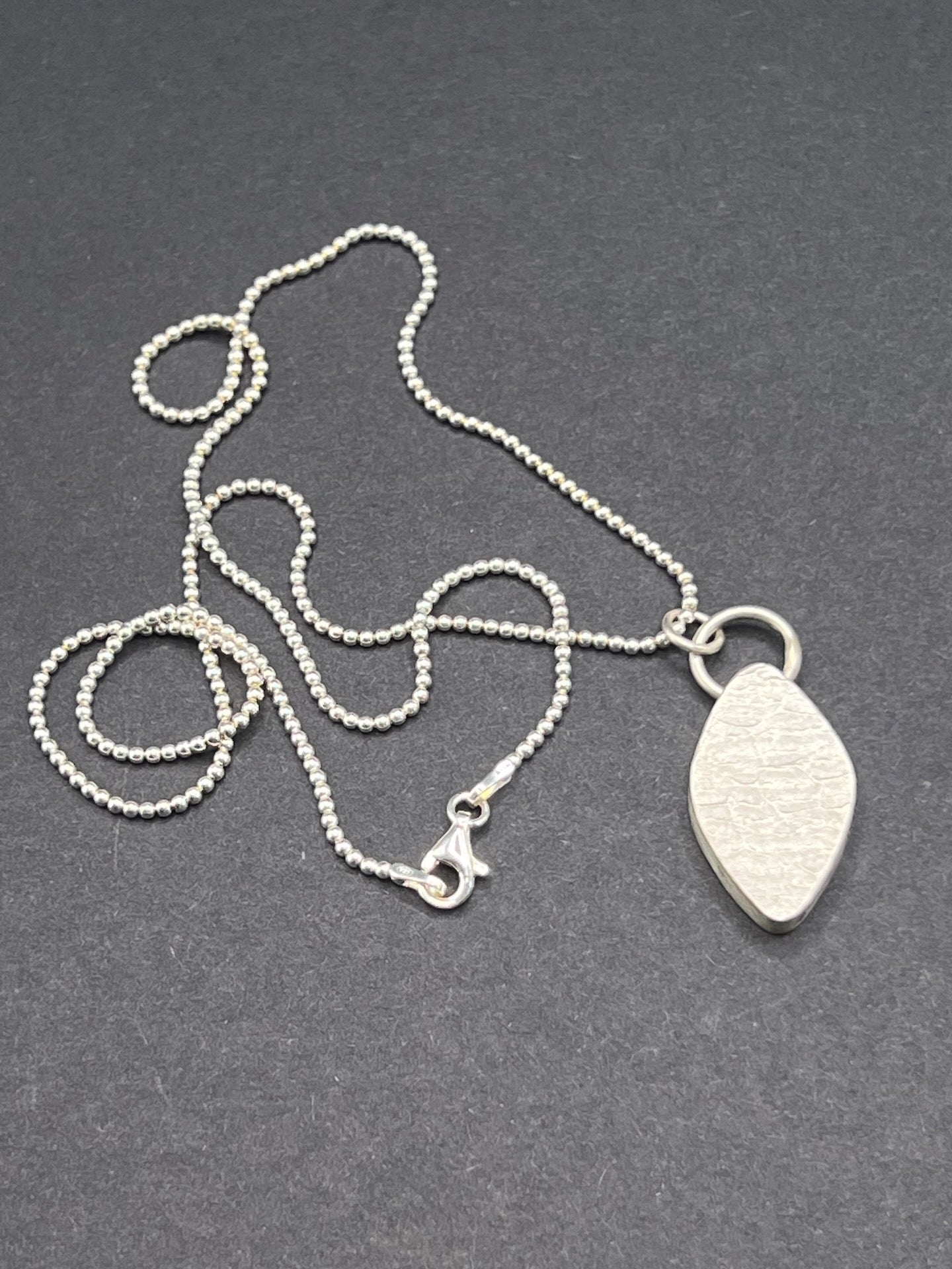 Hollow form, diamond shaped pendant (circles/cells pattern)