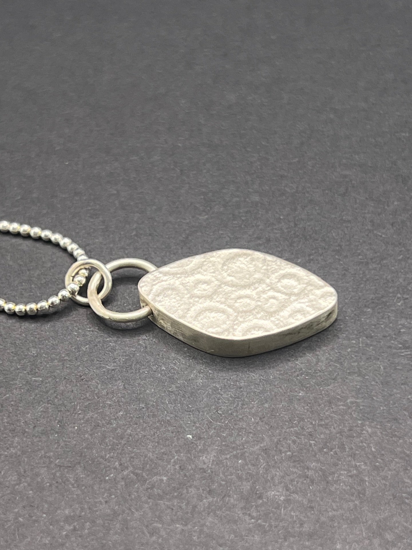 Hollow form, diamond shaped pendant (circles/cells pattern)