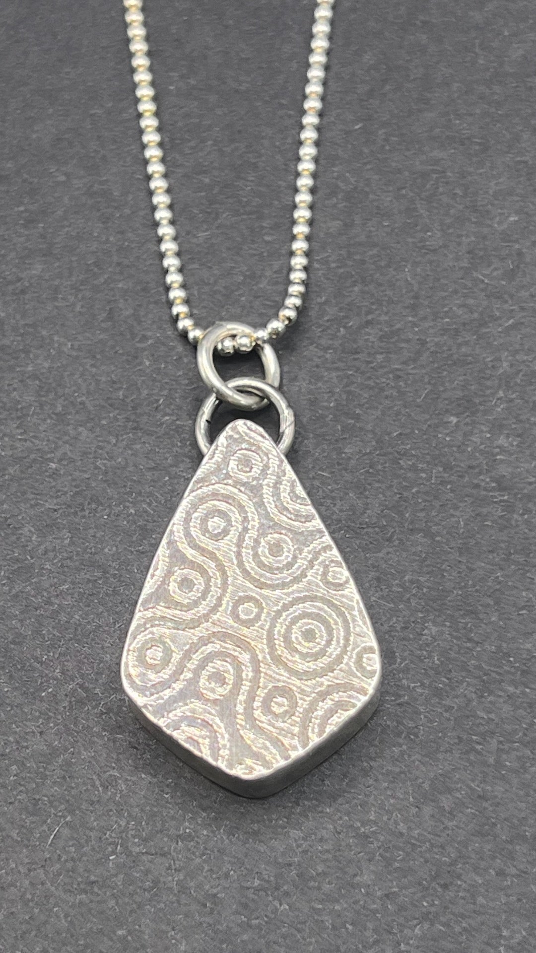 Hollow form, reversible teardrop pendant (pebble/spiral pattern)