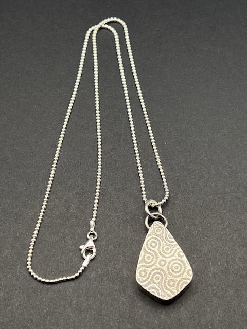 Hollow form, reversible teardrop pendant (pebble/spiral pattern)