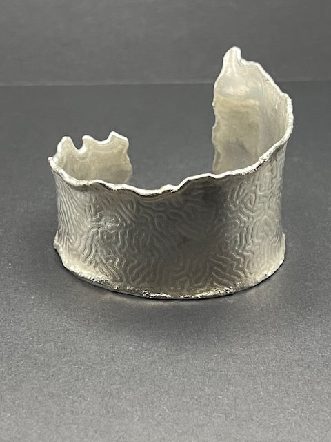 Asymmetrical torn edge coral cuff