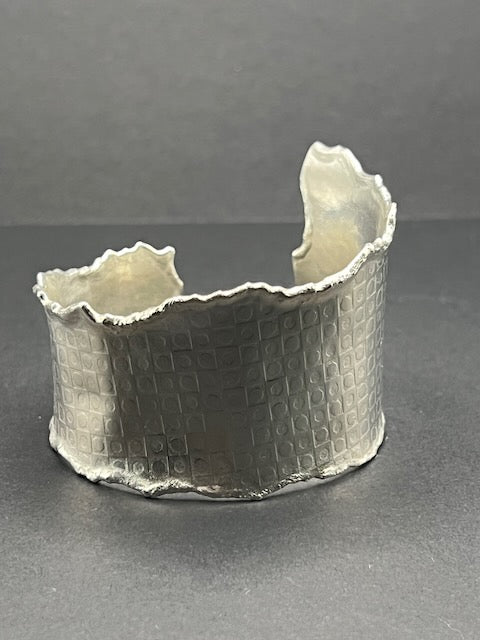 Asymmetrical torn edge checkerboard cuff
